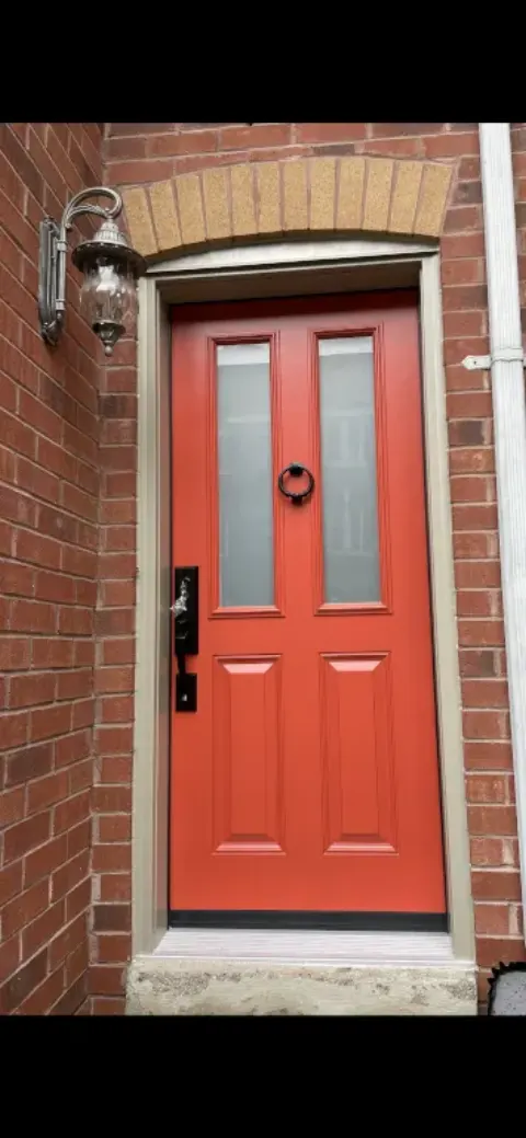 red entry door with two windows